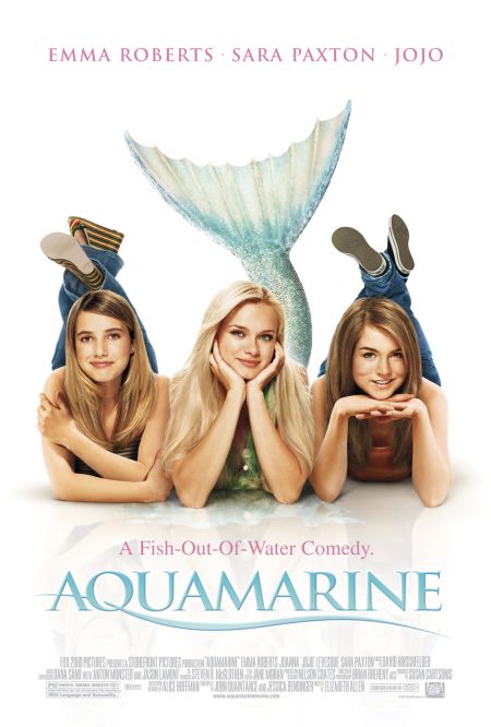 White background with three white girls lying on their bellies framing their faces with their hands. The two on the edge are wearing jeans and have brown hair. The one in the middle is blonde and has a mermaid tail. Text: A Fish-Out-Of-Water Comedy. Aquamarine.